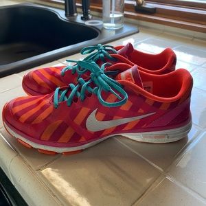 Pink and orange Nike shoes